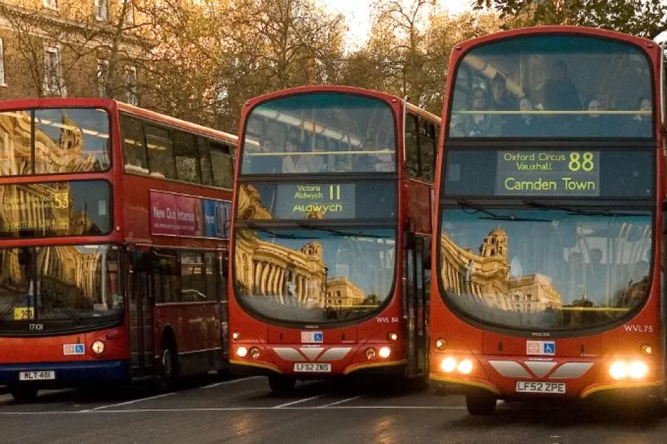 The fronts of three double-decker buses in London
